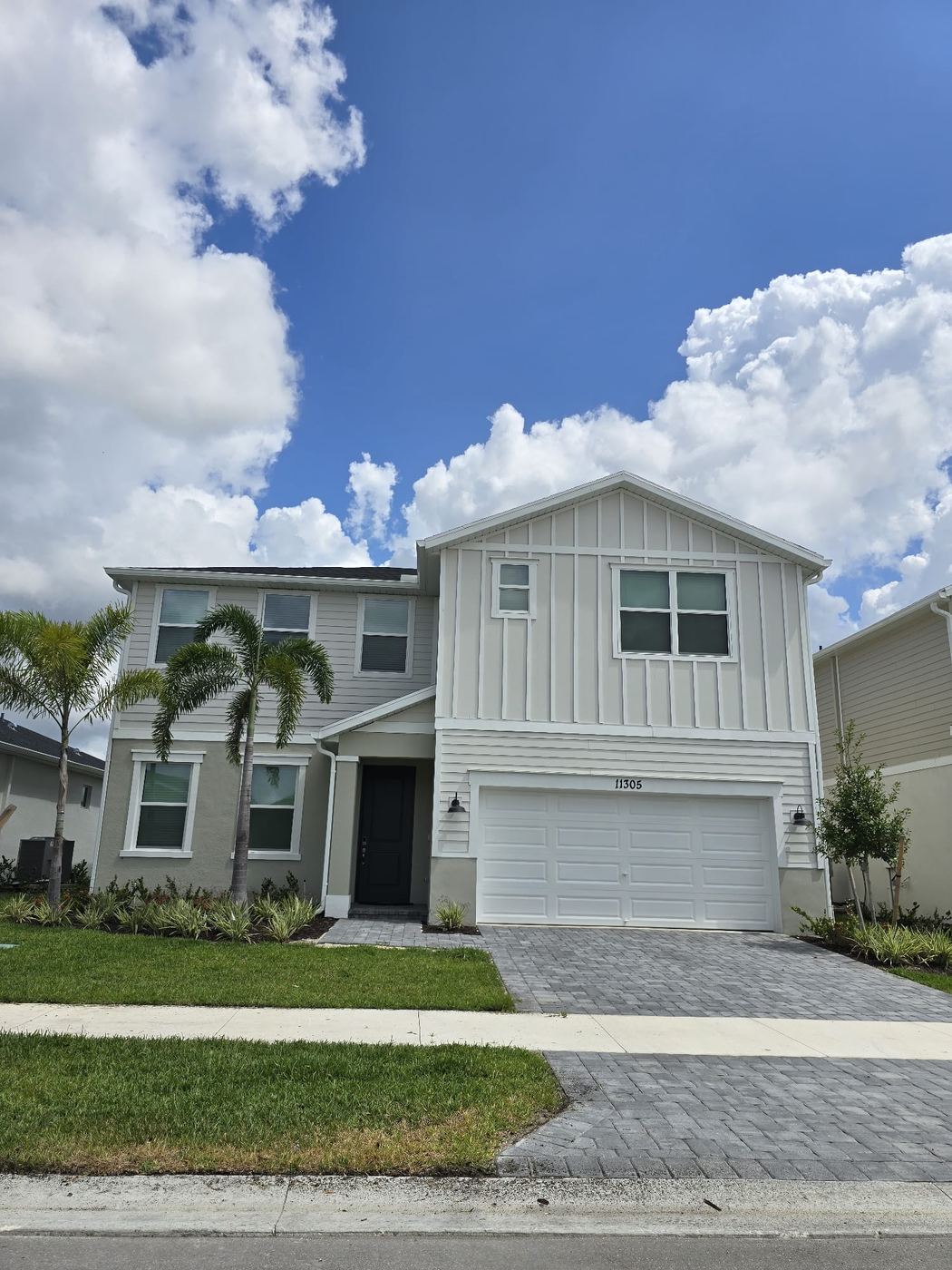White two-story home with lap siding