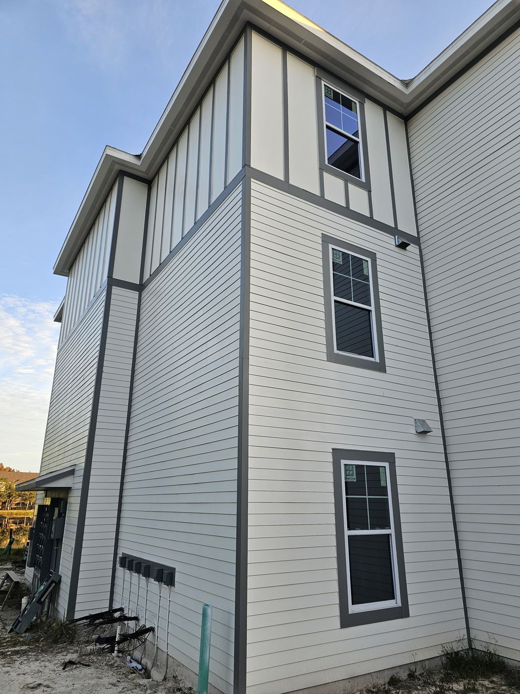 Tall building with white lap siding and trim