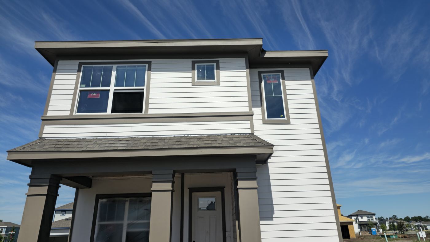 Home with white lap siding and dark trim