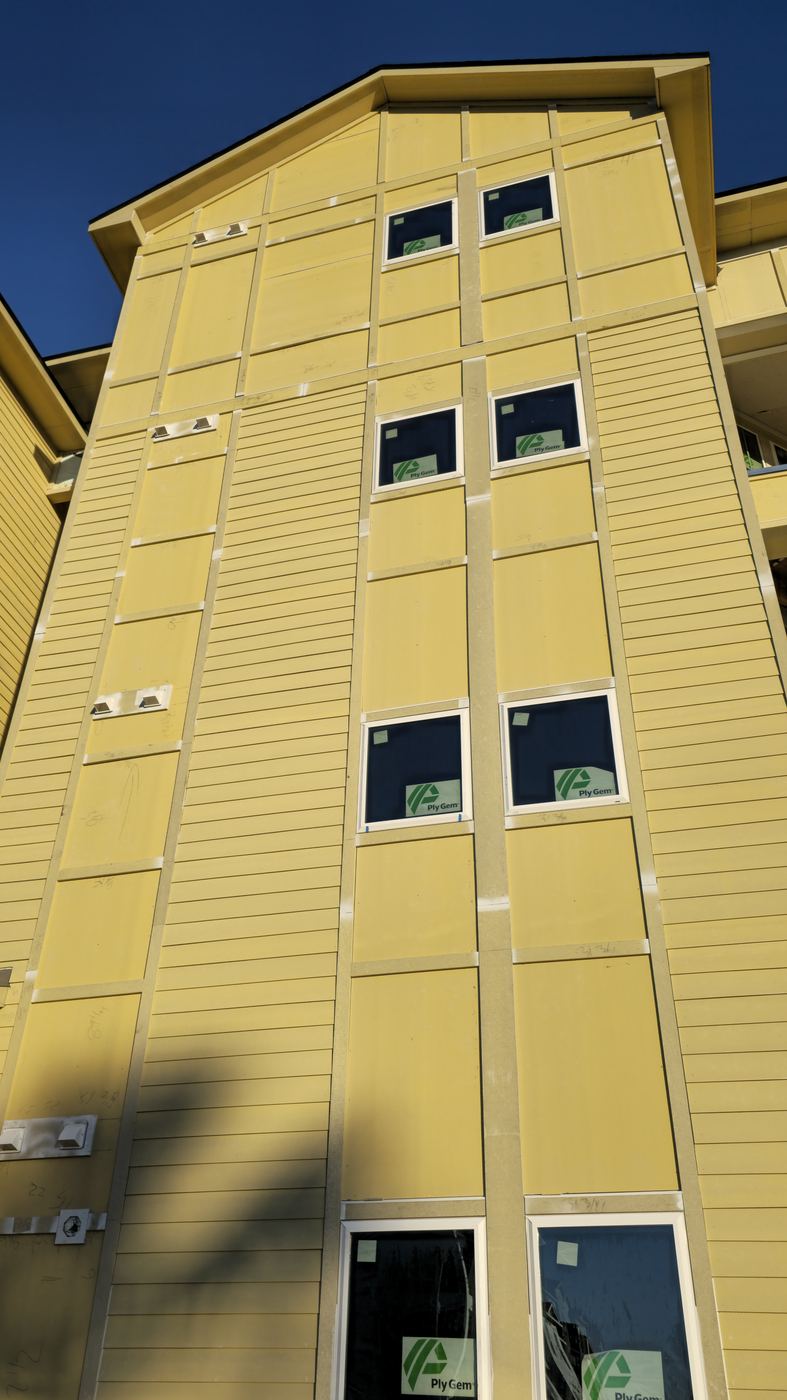 Tall facade with siding in progress