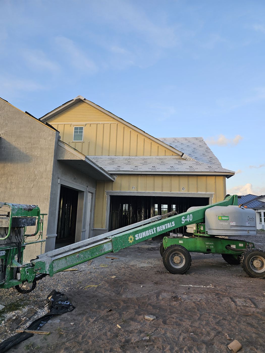 House wrap and siding with lift on site