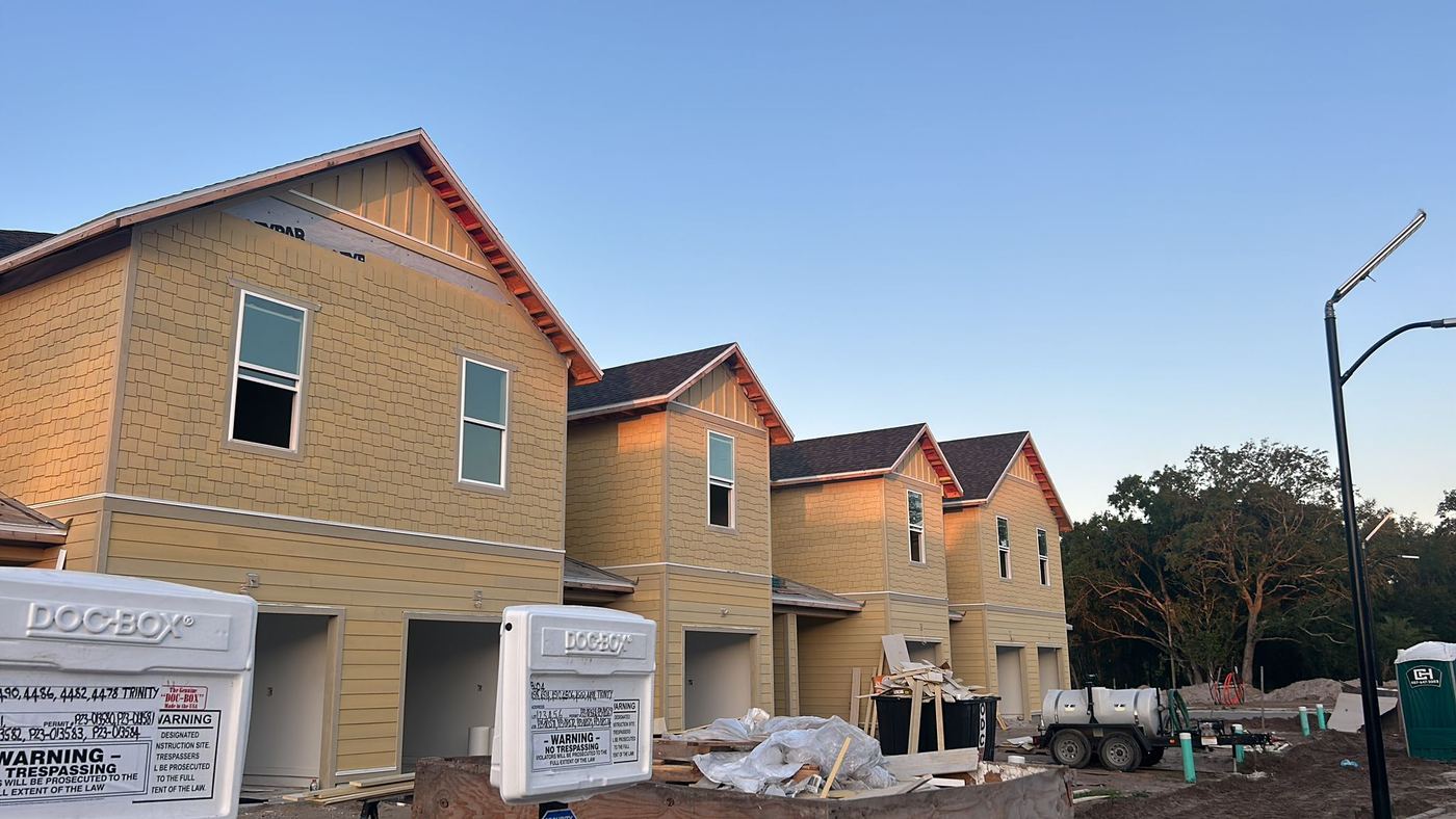 Row of townhomes with siding in progress